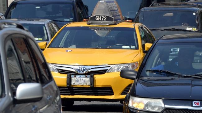 A New York City Taxi comes down 2nd Avenue in New York on July 10, 2014. The battle between ride-sharing and traditional taxi service is heating up in New York, with a new rival for ride-seekers declared illegal even before launching. Lyft, a ride-sharing service that operates in 60 US cities and competes with the likes of Uber, announced plans to launch Friday in the city boroughs of Brooklyn and Queens, claiming these communities are "vastly underserved" by existing transport options. Lyft said it had recruited 500 drivers in the Big Apple and that 75,000 New Yorkers had downloaded its mobile application ahead of the launch. The municipal agency said in a statement that Lyft "is unauthorized in New York City" and has failed to comply with safety and licensing requirements. AFP PHOTO / Timothy A. CLARY