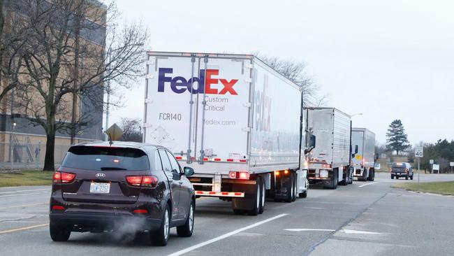 Trucks carrying the first shipment of the COVID-19 vaccine that is being escorted by the US Marshals Service, leave Pfizer's Global Supply facility in Kalamazoo, Michigan on December 13, 2020. Picture: AFP