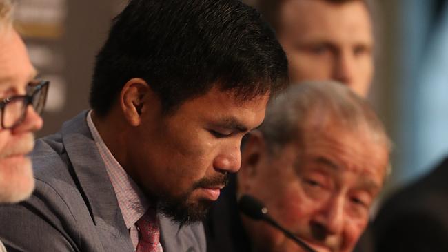 Manny Pacquiao sits on his phone.