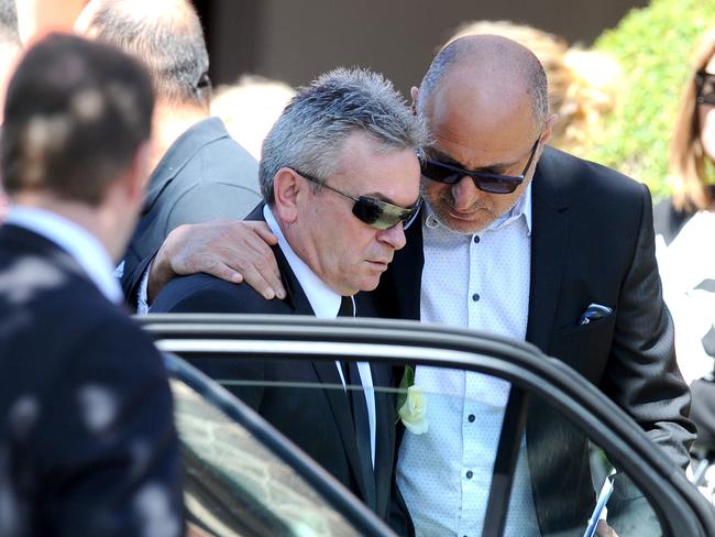 Borce Ristevski is comforted as he leaves the service. Picture: AAP