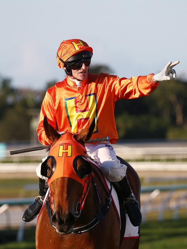 Jockey Robert Thompson celebrates as he returns to scale on The Harrovian after winning the Cairns Amateurs Cup at Cannon Park. PICTURE: BRENDAN RADKE