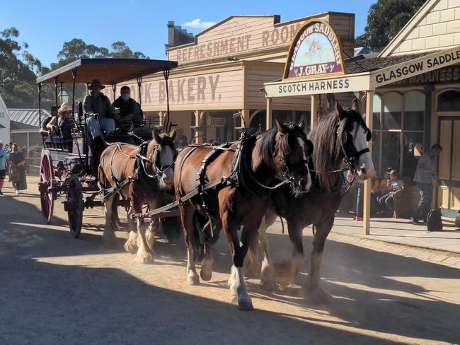 Sovereign Hill visitors ride the carriage through town.