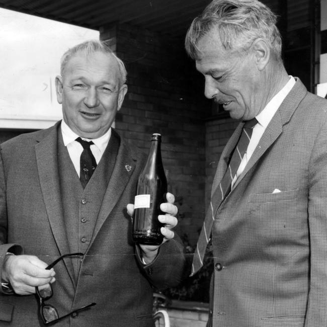 South Australian Premier Sir Thomas Playford and Santos general manager Mr J Klug with the first bottle of distillate from the Gidgealpa No. 2.