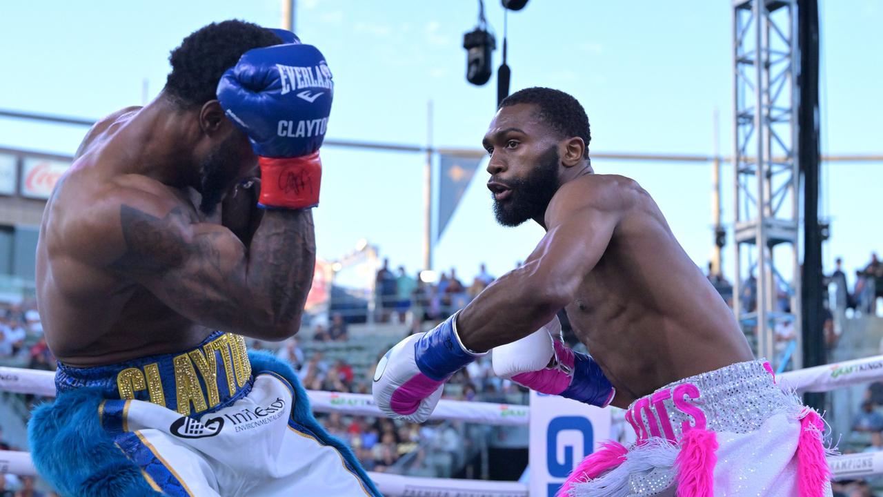 Rising star Jaron Ennis (R) knocked out Custio Clayton in a welterweight title eliminator.