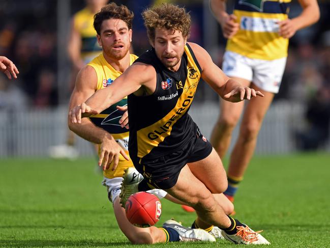 04/05/19 - Sanfl: Glenelg v Eagles at Glenelg Oval.  Glenelg's Matthew Snook pounces on the ball in front of Eagles' Jordan Foote. Picture: Tom Huntley