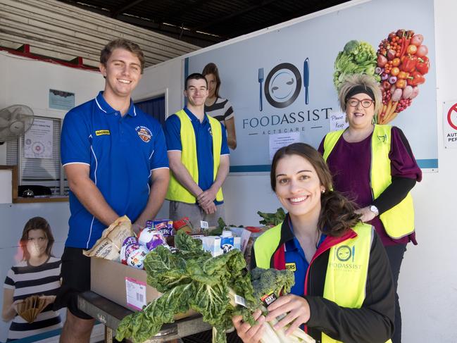 ( From left ) Assistant coach Matt Cox, Jordan Biggar, Tracey Twidale with Annette Rose, general manager Actscare. Toowoomba Mountaineers players help out at Foodassist. Friday, 1st May, 2020.