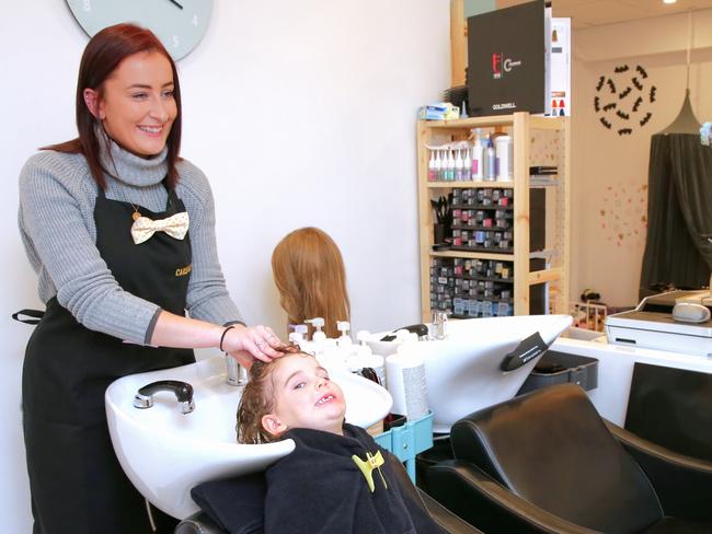 Carlo &amp; Elise hairdresser Bryony Buffery tends to Poppy Pope, 3 in the new Mosman salon. Picture: Adam Ward