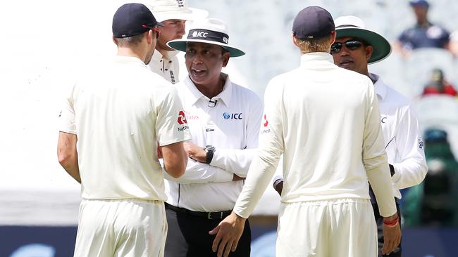 Field umpires talk to Joe Root and Jimmy Anderson. Picture: Michael Klein.