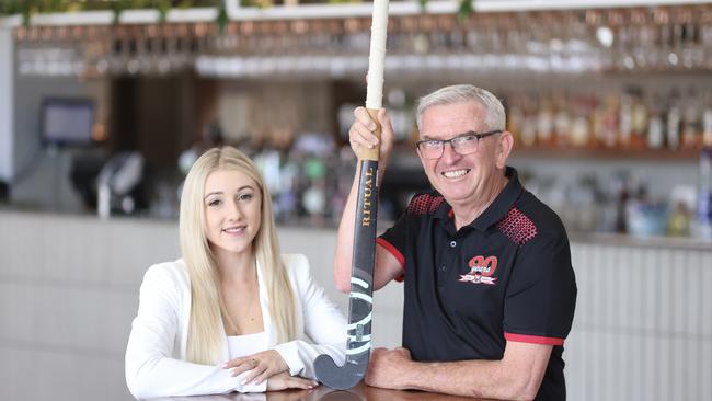 Komo events and marketing manager Sarah Casey and Redcliffe Leagues hockey club member Paul Greentree.