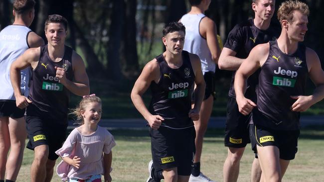 Richmond’s Trent Cotchin and his oldest daughter, Harper, training with the players at training. Picture: Michael Klein