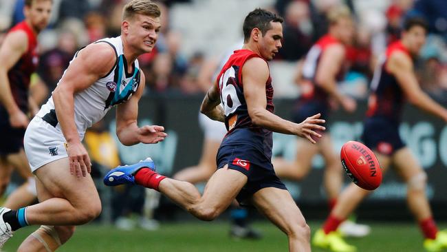Jeff Garlett of the Demons kicks the ball forward.