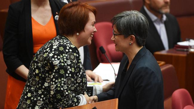 Penny Wong (R) congratulates Labor Senator Kimberley Kitching after she made her maiden speech in the Senate chamber at Parliament House in 2016. Picture: AAP