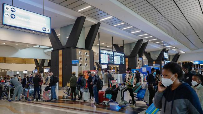 Travellers queue at a check-in counter at OR Tambo International Airport in Johannesburg as a flurry of countries around ban flights from southern Africa following the discovery of the Omicrom variant. Picture: Phill Magakoe / AFP