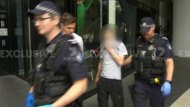 One of the alleged teen offenders being escorted by police. Picture: 7News Gold Coast.