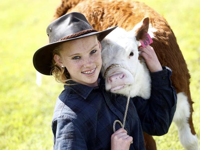 Jordan River Learning Federation farm student Sky Langford, 14. with Molly, a three-week-old calf, at the Show.