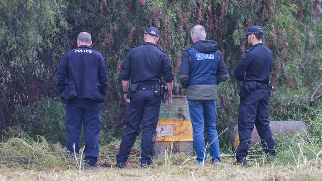 Police search through trees in a vacant paddock in Salisbury South, where a decomposed body was found, October 25, 2022. Picture: Brenton Edwards