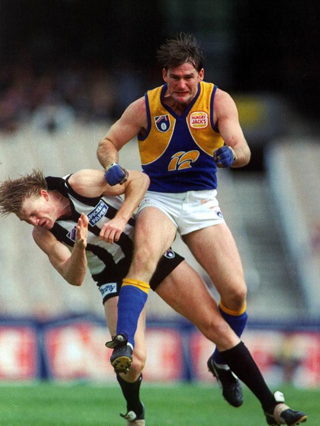 Peter Wilson gets the better of Nathan Buckley, who for a long time let his self-worth be defined by his AFL career.