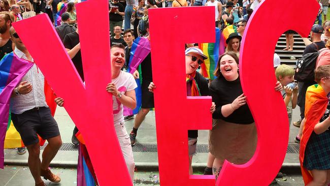 MELBOURNE, AUSTRALIA - NOVEMBER 15:  People in the crowd celebrate as the result is announced during the Official Melbourne Postal Survey Result Announcement at the State Library of Victoria on November 15, 2017 in Melbourne, Australia. Australians have voted for marriage laws to be changed to allow same-sex marriage, with the Yes vote defeating No. Despite the Yes victory, the outcome of Australian Marriage Law Postal Survey is not binding, and the process to change current laws will move to the Australian Parliament in Canberra.  (Photo by Scott Barbour/Getty Images)