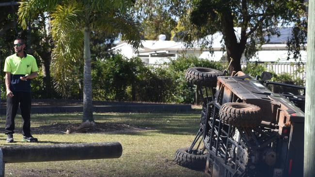 Police and detectives swarmed on the quiet Bundaberg suburb of Kalkie after a stolen council work car was crashed in the park on Kingsford St. A man looks at the crash scene.