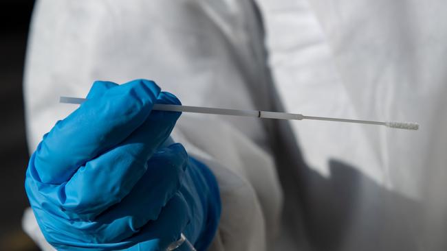 A nurse shows a sample collected from a person at a COVID-19 screening-drive in Neuilly-sur-Seine. Picture: Bertrand Guay/AFP.