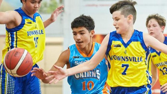 Sean O’Reilly from Cairns Marlins tries to get past Gabriel Canto and Dylan Brown from the Townsville Heat in 2020. Picture: Romy Bullerjahn