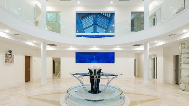 The foyer of the beach house with the peeking window in the background to see who’s at the door.