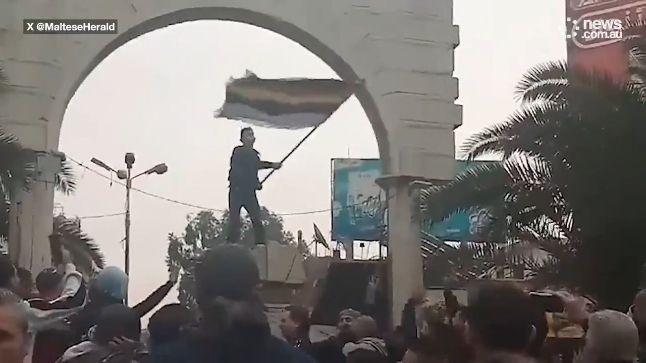 A statue of Hafez al-Assad has been toppled in a Damascus neighbourhood