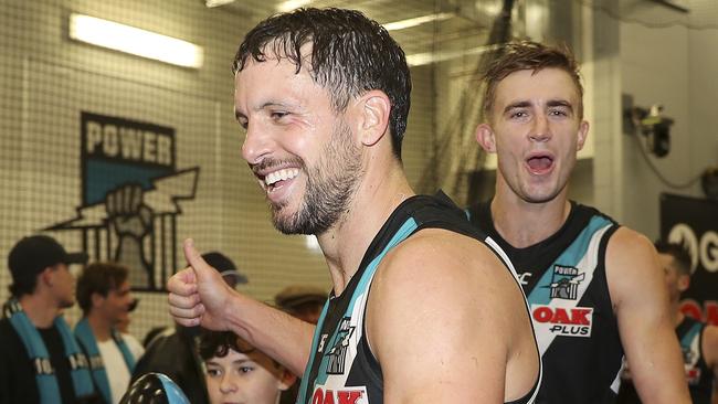 Port Adelaide’s Travis Boak gives the thumbs up as he walks back into the rooms with Dougal Howard after the win on Saturday night. Picture: Sarah Reed