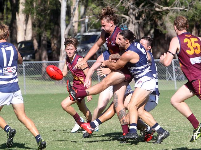 QAFL grand final replay between premiers Palm Beach Currumbin and Broadbeach at Salk Oval. Photo of Nicholas Crowley kicking a goal under pressure.