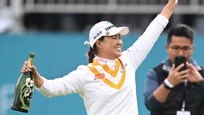 Australia's Minjee Lee (L) celebrates her victory at the end of the BMW Ladies Championship . (Photo by Jung Yeon-je / AFP)