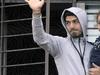 Uruguay's soccer player Luis Suarez holds his daughter as he greets fans from their home's balcony on the outskirts of Montevideo, Uruguay, Friday, June 27, 2014. Suarez returned to Montevideo early Friday, arriving too late to see the hundreds of Uruguay fans who had gathered the previous night to give him a hero's welcome despite his World Cup banishment. (AP Photo/Matilde Campodonico)