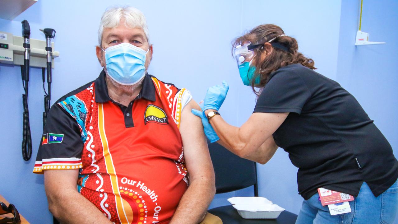 Local Indigenous Leader John Paterson getting his booster shot from Aboriginal Health Practitioner Brenda Martin-Jard at the Danila Dilba facility in Palmerston. Picture: Glenn Campbell