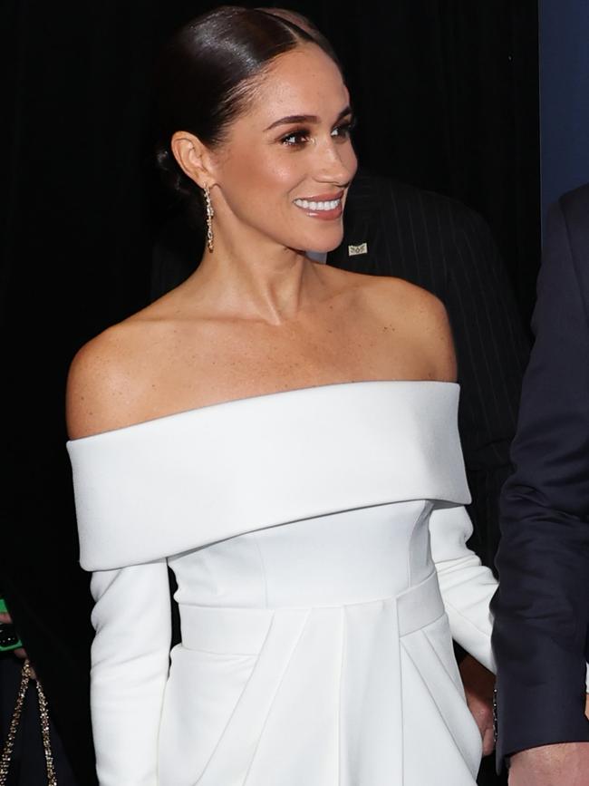 Meghan’s off-the-shoulder white dress has been compared to one worn by Catherine, Princess of Wales. Picture: Getty