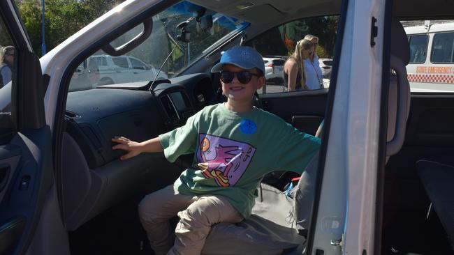 Elijah in the front seat of the police car