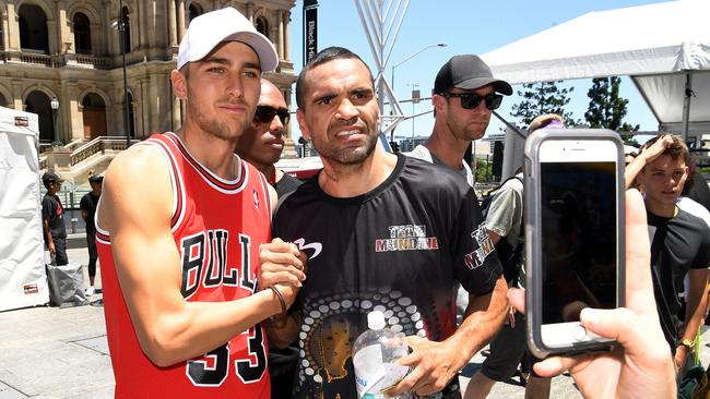 Anthony Mundine with a fan after a promotional training session in central Brisbane. Picture: AAP Image/Dan Peled