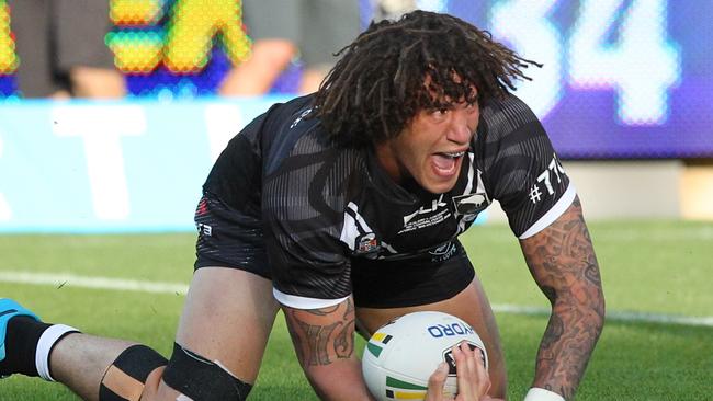 Kevin Proctor for the Kiwis celebrates after scoring a try.