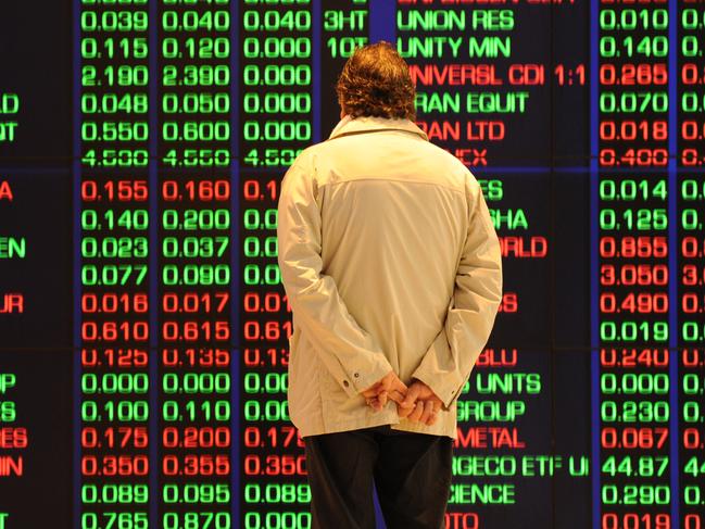 YOUR MONEY : An investor watches the share price monitors at the Australian Stock Exchange (ASX) in Sydney on August 19, 2011. Australian stocks slumped 2.75 percent following steep falls on international markets amid new worries that Europe and the US are sinking into recession.  AFP PHOTO / Torsten BLACKWOOD