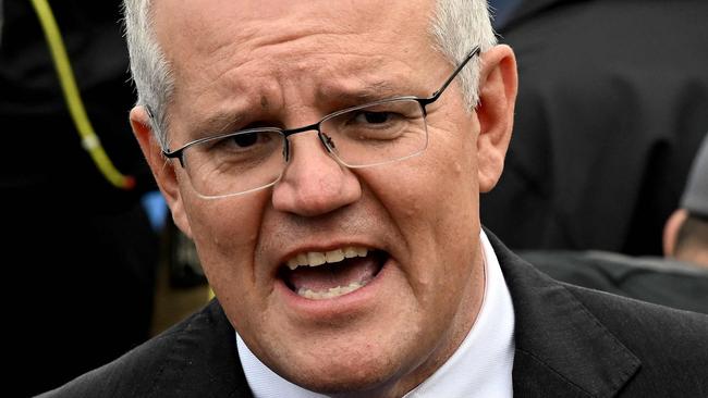 Australian Prime Minister Scott Morrison speaks to the press after casting his vote outside a polling station during the Australian general election in Sydney on May 21, 2022. (Photo by SAEED KHAN / AFP)