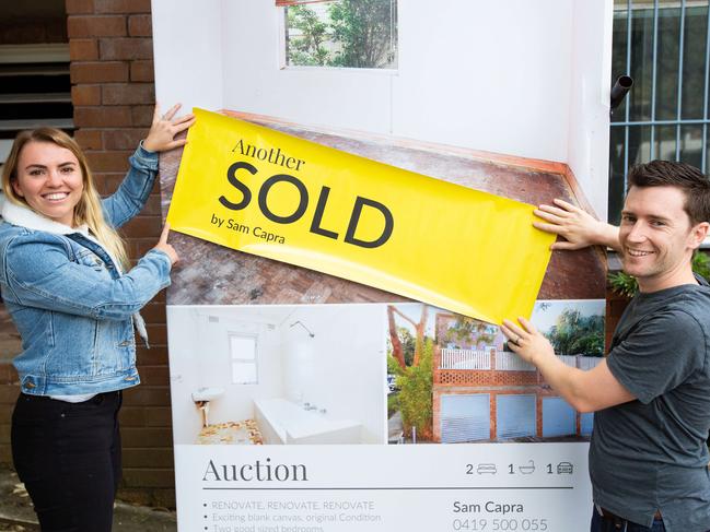 New owners Aimie and Josh Devenny pose for a picture in front of their new home.Picture: Luke Drew