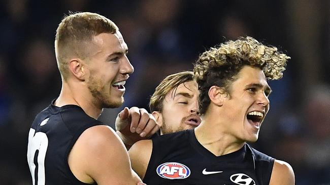 Charlie Curnow celebrates a goal with fellow key forward Harry McKay.