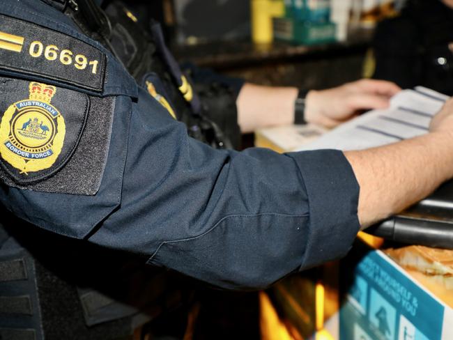 ABF officers check documents during a raid on a city brothel. Picture: Supplied ABF.