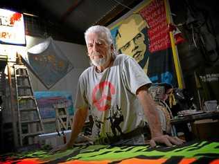 Peace activist Graeme Dunstan works on a banner. Picture: Chris Ison ROK300317cdunstan2