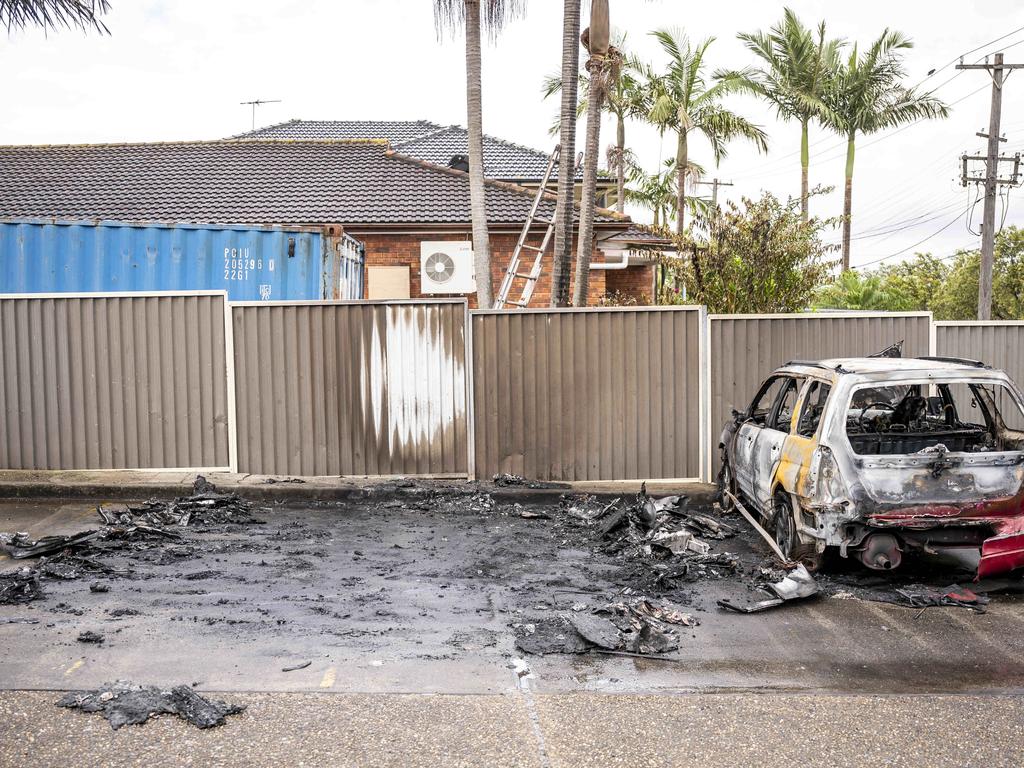 Corner of Murray St and Lawford St, Greenacre, the site of a suspected burnt out car. The car has been removed by police but the surrounding cars and property have been damaged.