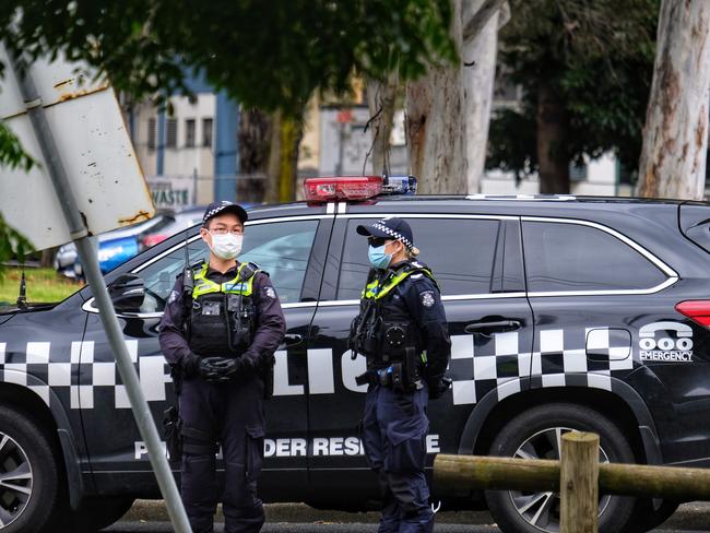 Police maintain a lockdown of the housing commission flats in Flemington. Picture: Luis Enrique Ascui