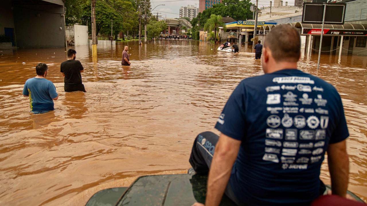 Volunteers help rescue people in flood-hit areas in Porto Alegre. Picture: Carlos Fabal / AFP