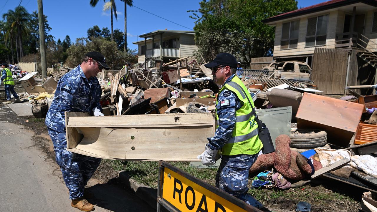 Members of the Australian Defence Force (ADF) help with the clean up of flood affected properties in Brisbane. Picture: NCA NewsWire / Dan Peled