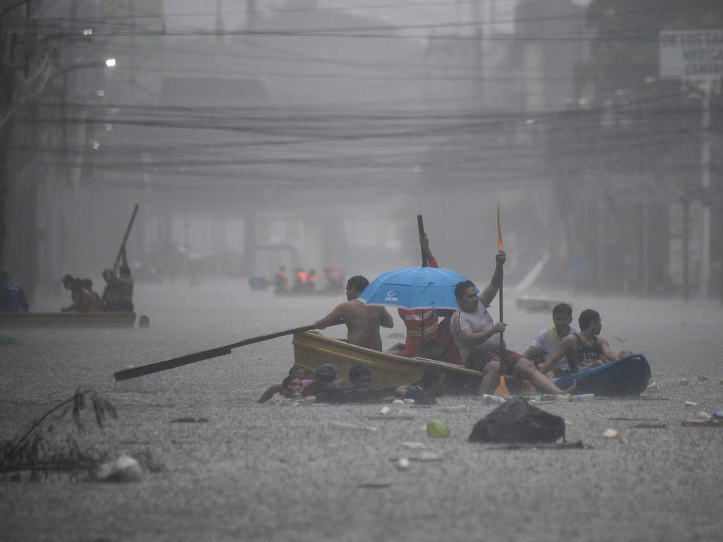 Rescuers paddle their boats along a flooded street amid heavy rains brought by Typhoon Gaemi, in Manila, on July 24, 2024.. Relentless rain drenched the northern Philippines on July 24, triggering flooding in Manila and landslides in mountainous regions as Typhoon Gaemi intensified the seasonal monsoon. Picture: AFP