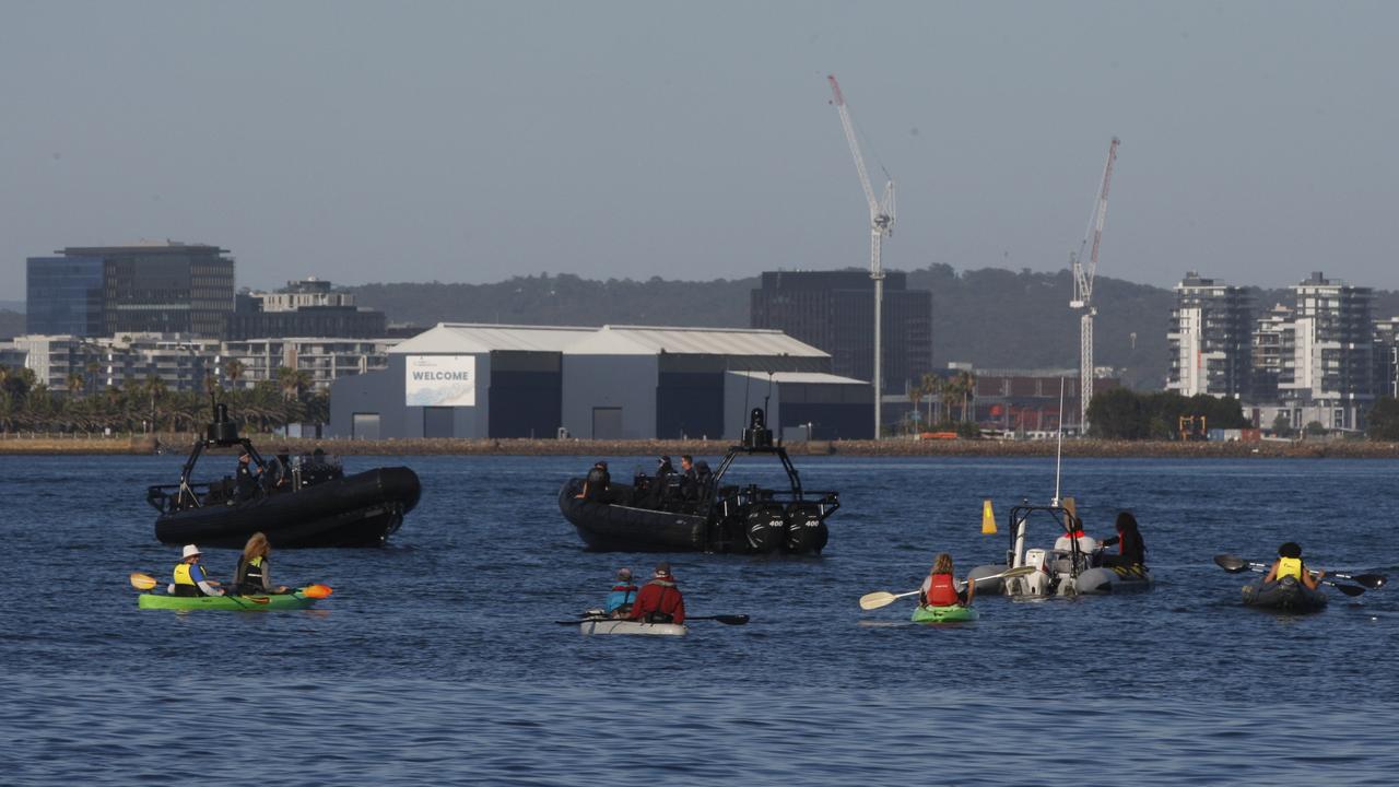 NSW Police Maritime Area Command vessels kept protesters at bay while a bulk carrier exited the Port of Newcastle on Saturday. Picture: NewsWire/Dean Sewell.