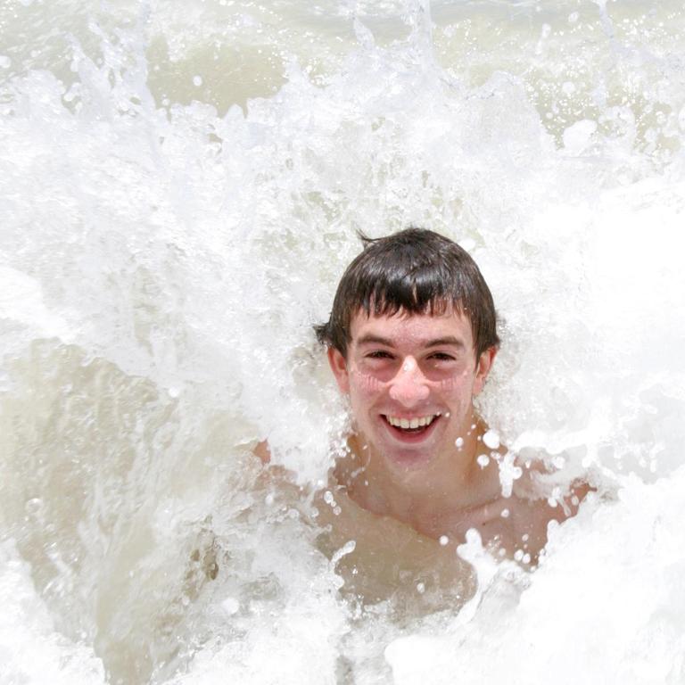 Socceroo Tommy Oar rides as a wave at Kurrawa in 2007.