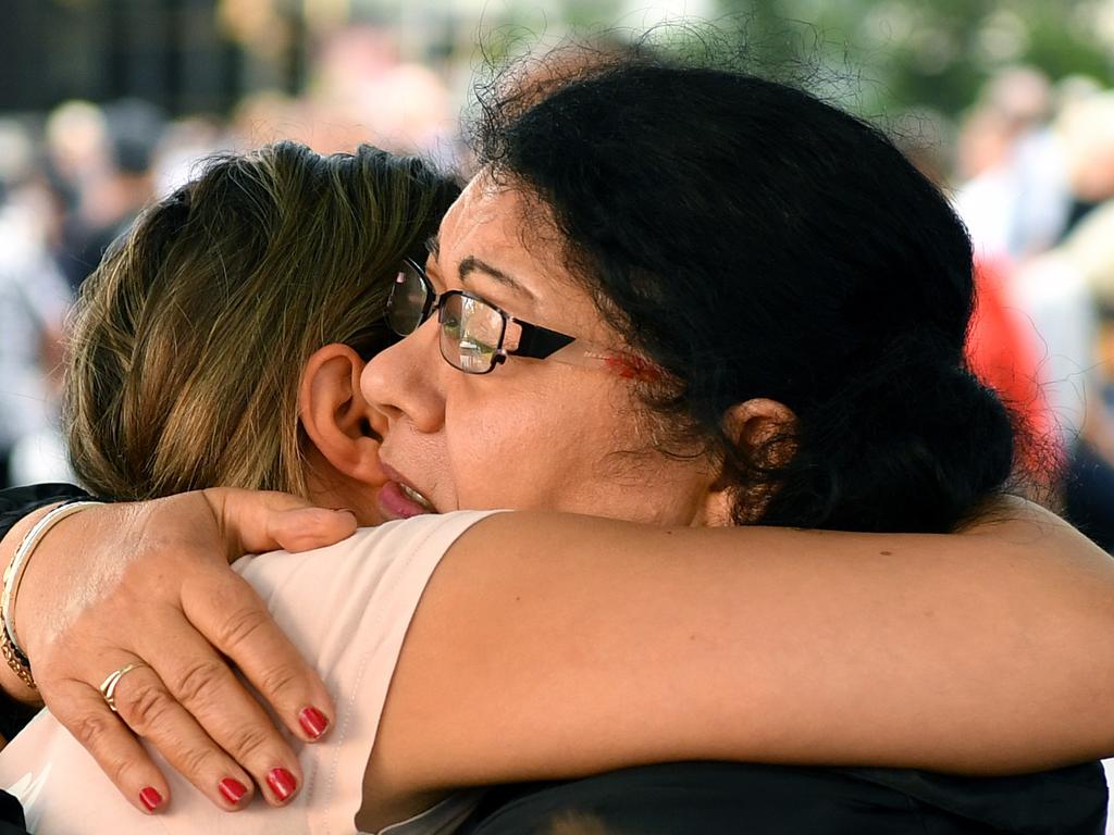 Families embrace one another as they disembark from the Ovation of the Seas in Sydney. Picture: AAP Image/Joel Carrett.